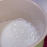 Met die hand melk opschuimen vir 'n cappuccino